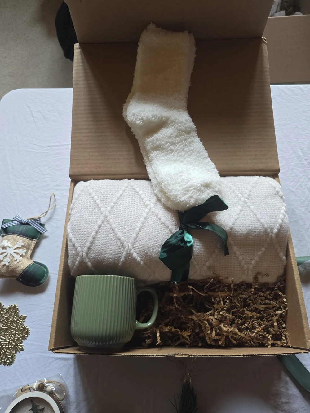 Holiday Home Gift Box with Cream Knit Throw and Green Ribbon Accents
